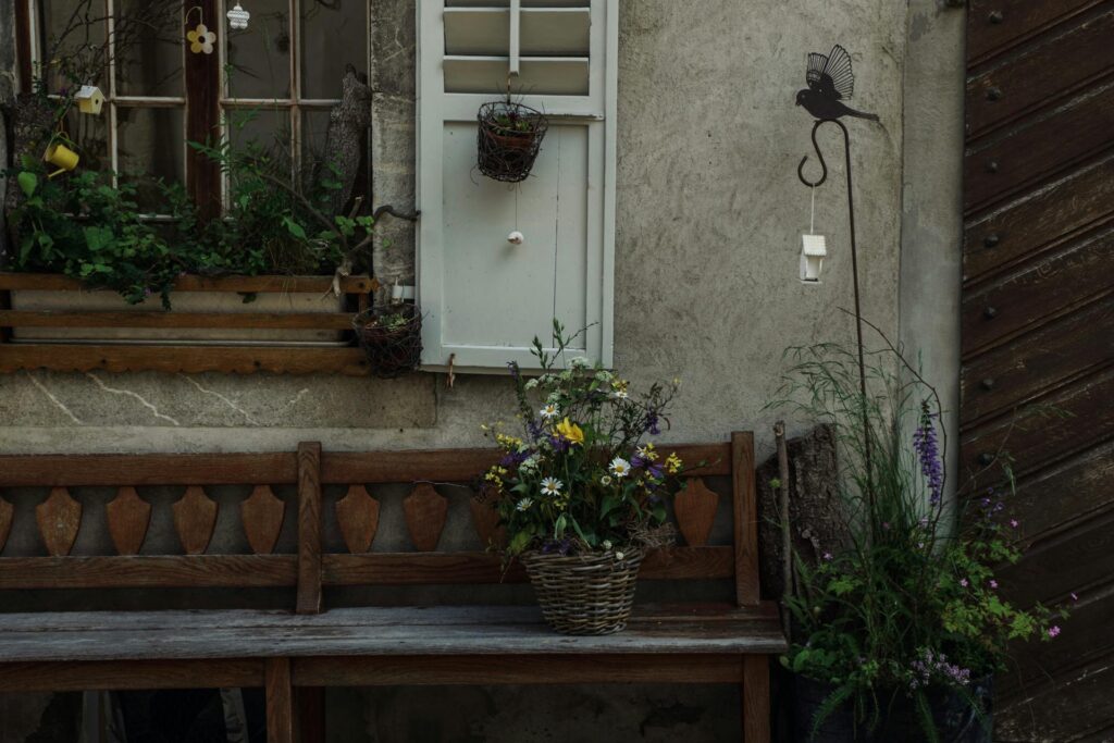 inner security space with wooden bench, wildflowers in a basket, and natural rustic garden setting